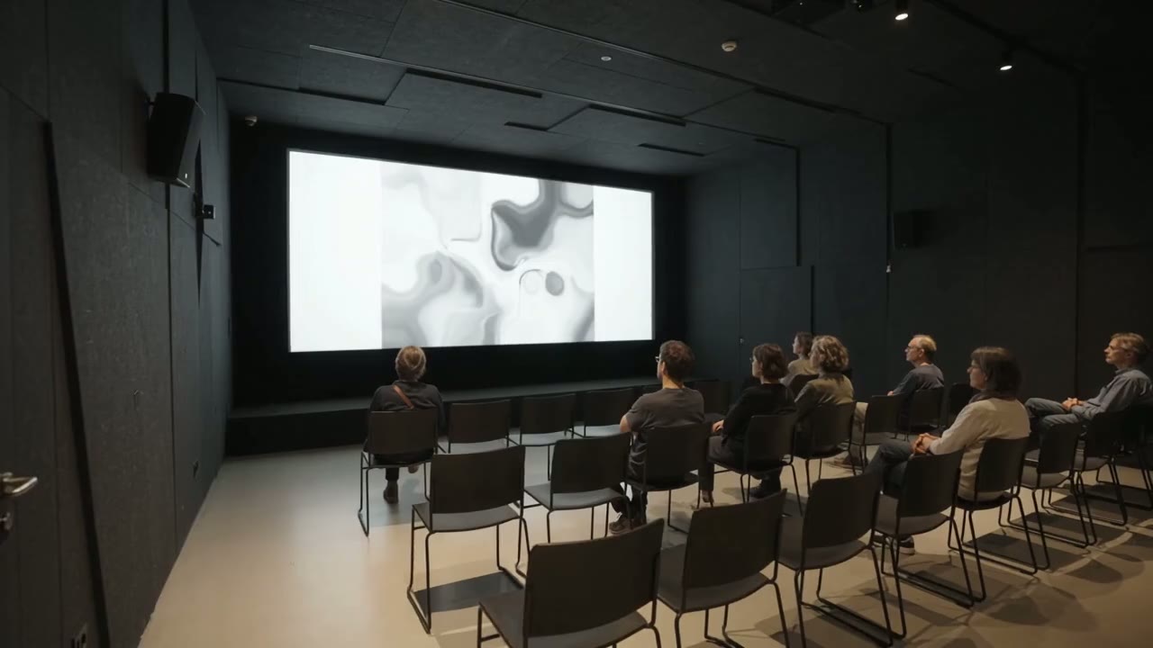 Visitors watching a screening in the micro-cinema
